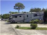 View larger image of A motorhome in a back in RV site at MAJESTIC OAKS RV RESORT image #11