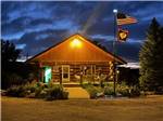 The main lodge office at dusk at TWIN PINES RV PARK & CAMPGROUND - thumbnail