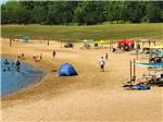 View larger image of People on the beach under canopies at CHAPPARAL CAMPGROUND  RESORT image #2