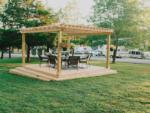 Wicker chairs and table under a pergola at SILVER SPRINGS RV PARK - thumbnail