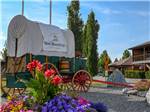 Close-up of covered wagon and welcome sign at BOW RIVERSEDGE CAMPGROUND - thumbnail