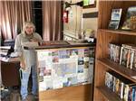 A woman standing behind the front desk at OLD WEST RV PARK - thumbnail