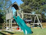 Playground with slide and swings at MOUNTAIN GLEN RV PARK & CAMPGROUND - thumbnail