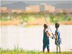 View larger image of Two children fishing in the lake at ISLETA LAKES  RV PARK image #6