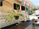 View larger image of A flower planter hanging next to a RV parked at BAKERSFIELD RIVER RUN RV PARK image #10