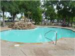View larger image of The pool with a waterfall at OAK CREEK RV PARK image #4