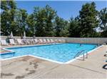 Lounge chairs around the swimming pool - thumbnail