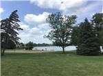 A grassy area by the water at LAKESHORE RV RESORT & CAMPGROUND - thumbnail