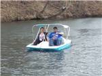 A couple on a paddleboat at AOK CAMPGROUND & RV PARK - thumbnail