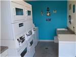 Laundry room with washer and dryers at CROSSROADS RV PARK - thumbnail