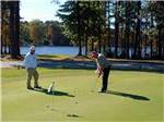 Two men playing golf at FOUR OAKS LODGING & RV RESORT - thumbnail