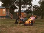 People sitting around a fire pit at SILVER COVE RV RESORT - thumbnail