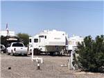 A fifth wheel trailer and truck in an RV site at 3 DREAMERS RV PARK - thumbnail