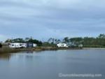 Lake with RV's parked near by at site The Refuge on Roanoke Island - thumbnail