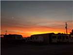 RVs parked in sites at sunset at COYOTE VIEW RV PARK & RV REPAIR - thumbnail