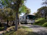Class A parked on a gravel site at YOSEMITE RV RESORT - thumbnail