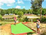 Girls playing miniature golf at THOUSAND TRAILS FOREST LAKE - thumbnail