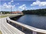 View larger image of A wooden walkway by the water at COASTAL GEORGIA RV RESORT image #9