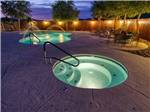 The swimming pool and hot tub at dusk at CAMPBELL COVE RV RESORT - thumbnail
