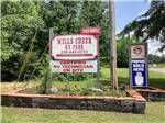 View larger image of Grassy RV sites with a pink sky at WILLS CREEK RV PARK image #1