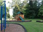 View larger image of Playground with wooden-ship play structure at MADISON VINES RV RESORT  COTTAGES image #8