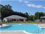 View larger image of A pool with building in background at MADISON VINES RV RESORT  COTTAGES image #11