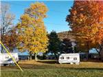 RVs camped near trees at COOL-LEA CAMP - thumbnail
