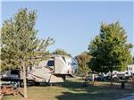 A fifth wheel trailer parked in a RV site at YOGI BEAR'S JELLYSTONE PARK AT DELAWARE BEACH - thumbnail