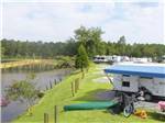 View larger image of Waterfront RV sites with grass at AVALON LANDING RV PARK image #2