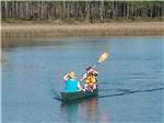 View larger image of Two people in a canoe on the bayou at AVALON LANDING RV PARK image #3