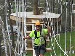 A man on the ropes course at WOOD'S TALL TIMBER RESORT - thumbnail