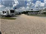A gravel road between RV sites at MONTGOMERY SOUTH RV PARK & CABINS - thumbnail