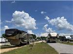 Looking down a couple of pull thru RV sites at MONTGOMERY SOUTH RV PARK & CABINS - thumbnail