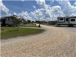 Planters in front of gravel RV sites at MONTGOMERY SOUTH RV PARK & CABINS - thumbnail