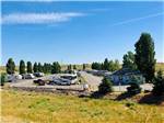 RV park with small blue campground office at COYOTE RUN RV PARK - thumbnail