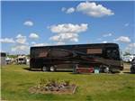 View larger image of Class A RV camping near flower bed with picnic table  at ST ALBERT RV PARK image #5