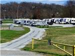 View larger image of Several RVs parked behind a yellow gate at RIVERSIDE GOLF  RV PARK image #7