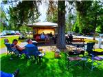A group of people listening to a man playing a guitar at LONE MOUNTAIN RESORT - thumbnail