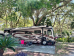 RV in tree lined site at Thousand Palms RV Resort - thumbnail