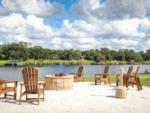 Chair's around fire pit with lake view at Moss Landing RV Resort - thumbnail