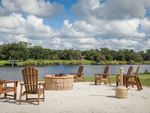 Chairs around a firepit with lake views at Moss Landing RV Resort - thumbnail