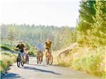 View larger image of A family riding bikes on a trail at EXPO CENTER RV PARK image #5