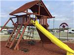 View larger image of Playground area with large slide at COFFEE CREEK RV RESORT  CABINS image #10