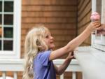 Girl being handed ice cream cone at PINEWOOD LODGE CAMPGROUND - thumbnail