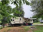 A travel trailer in a grassy RV site at PARKERS CROSSROADS CAMPGROUND - thumbnail