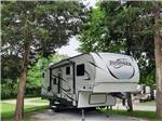 A fifth wheel trailer in a gravel RV site at PARKERS CROSSROADS CAMPGROUND - thumbnail