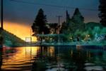 View of water and park at sunset - thumbnail