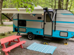 Camper with orange picnic table at Spacious Skies French Pond Campground - thumbnail