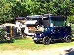 A motorhome parked under trees at SHADY KNOLL CAMPGROUND - thumbnail