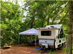 A pop up trailer under trees at SHADY KNOLL CAMPGROUND - thumbnail